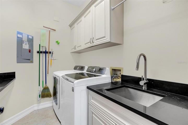 First Floor Laundry Room with large counter, sink and storage