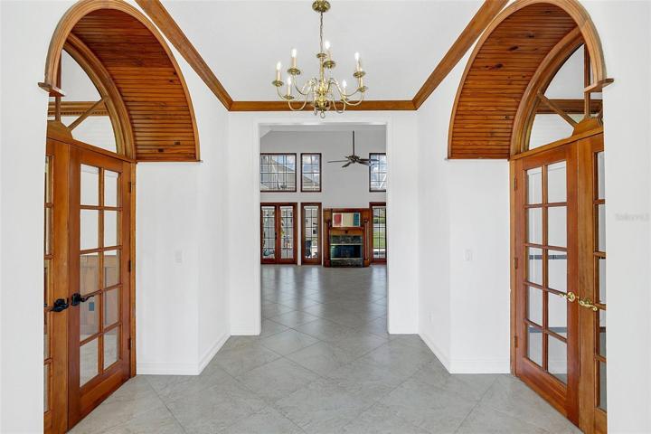Grand Entry Foyer with High Ceilings and Beautiful Wood Trim Overlooks Great Room