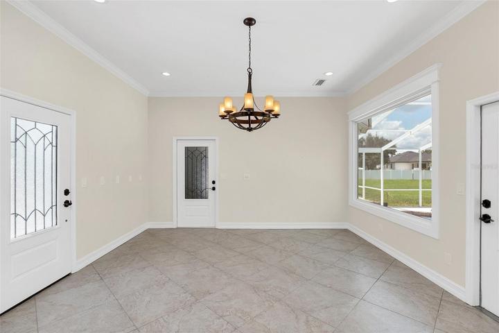 Abundant Breakfast Room with Gorgeous VIEWS to Screened Pool and Rear YardAccess to Garage and 2 Access doors to Outside