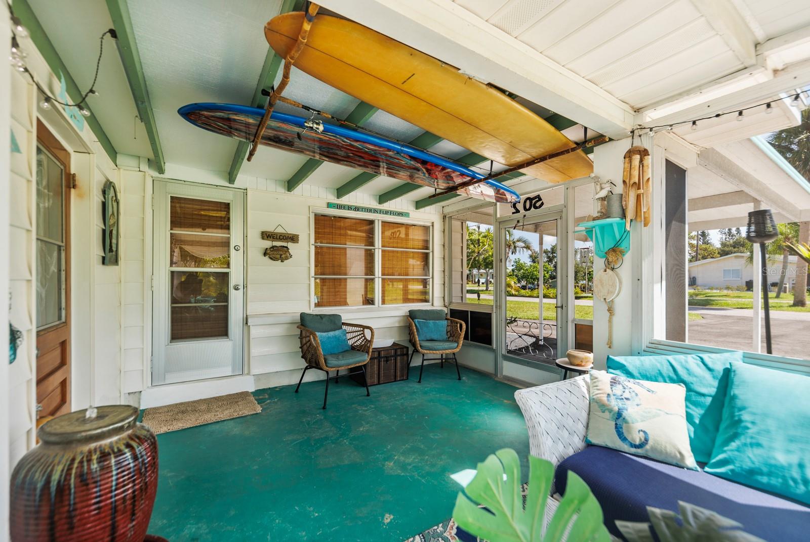 Surfs up dude! The metal door leads into the house and the wood door on the left leads to the laundry/storage room.