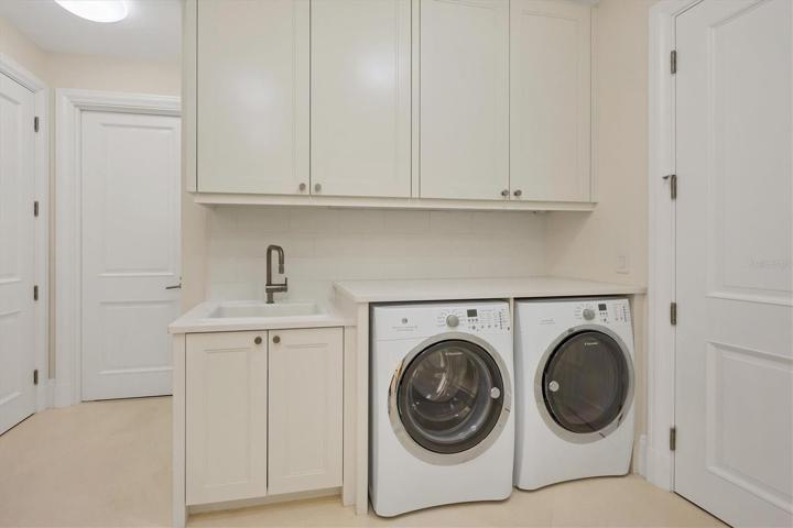 Generous Laundry Room with Cabinets & Sink