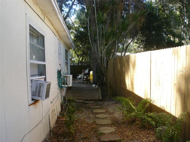 Walkway to one bedroom in rear bldg.  Has gated yard and deck