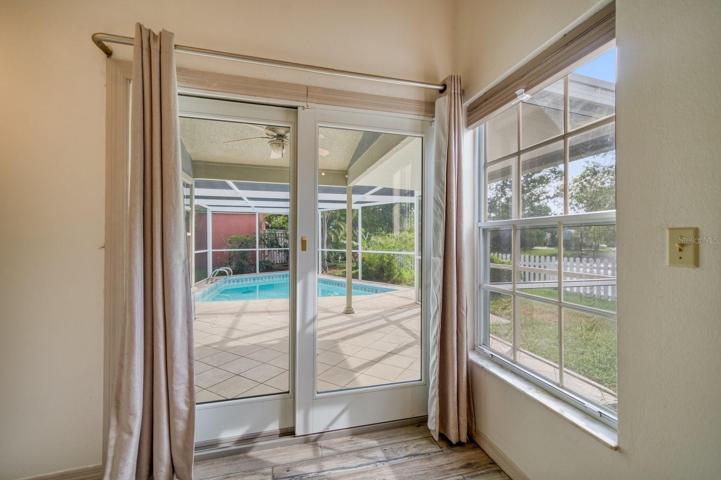 Primary Bedroom view looking onto pool & patio area.