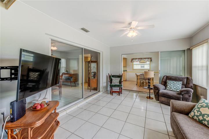 Large Florida Room that leads to back paved porch