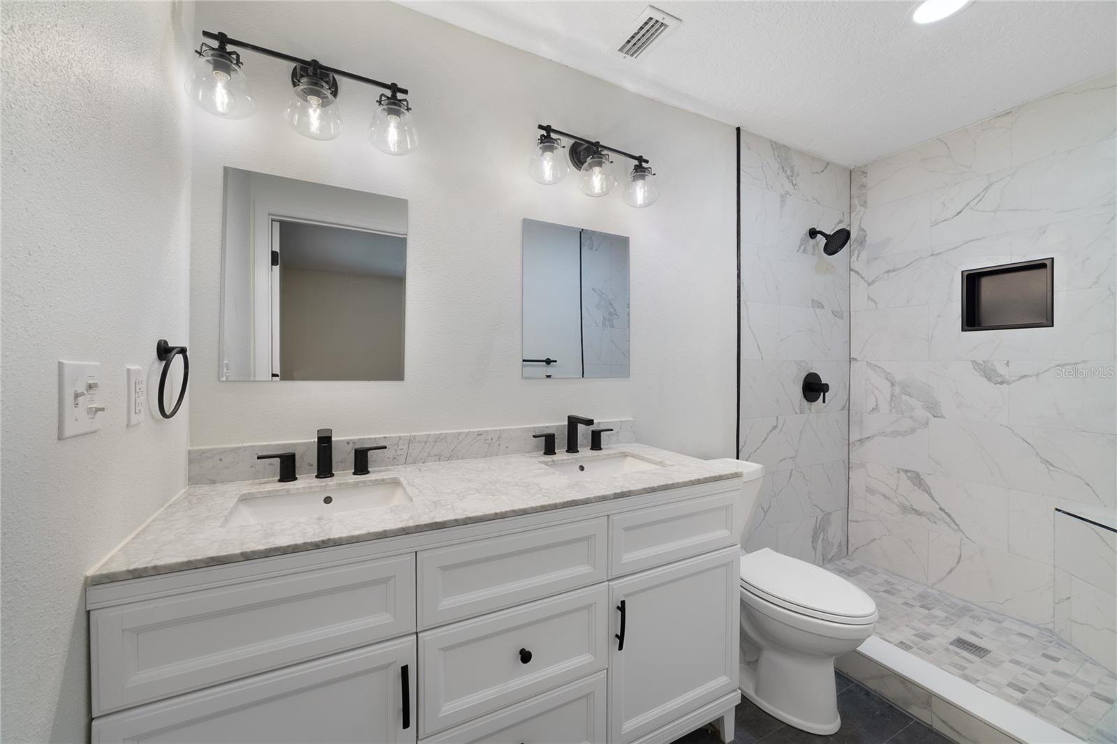 Your EN-SUITE has also been completely renovated in the same style as the kitchen with a DUAL SINK VANITY, chic light fixtures and a CUSTOM TILED SHOWER!