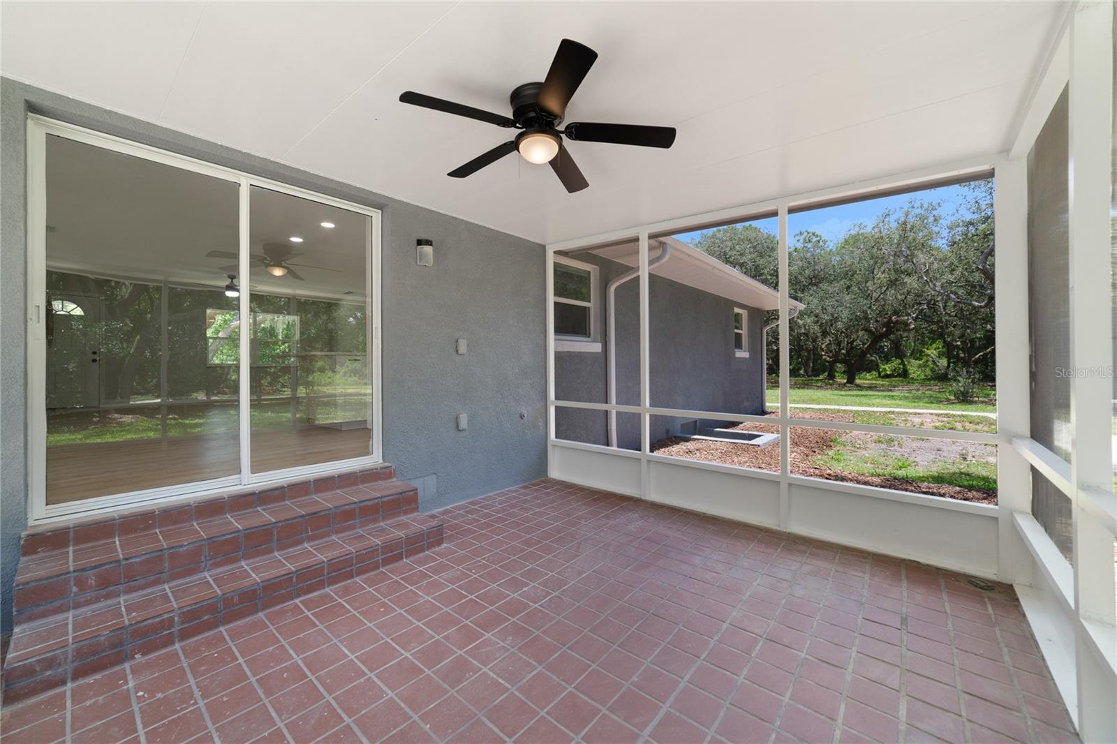 The SCREENED LANAI is the perfect place to enjoy the views this property delivers, a ceiling fan ensures comfort while you cookout with family and friends!