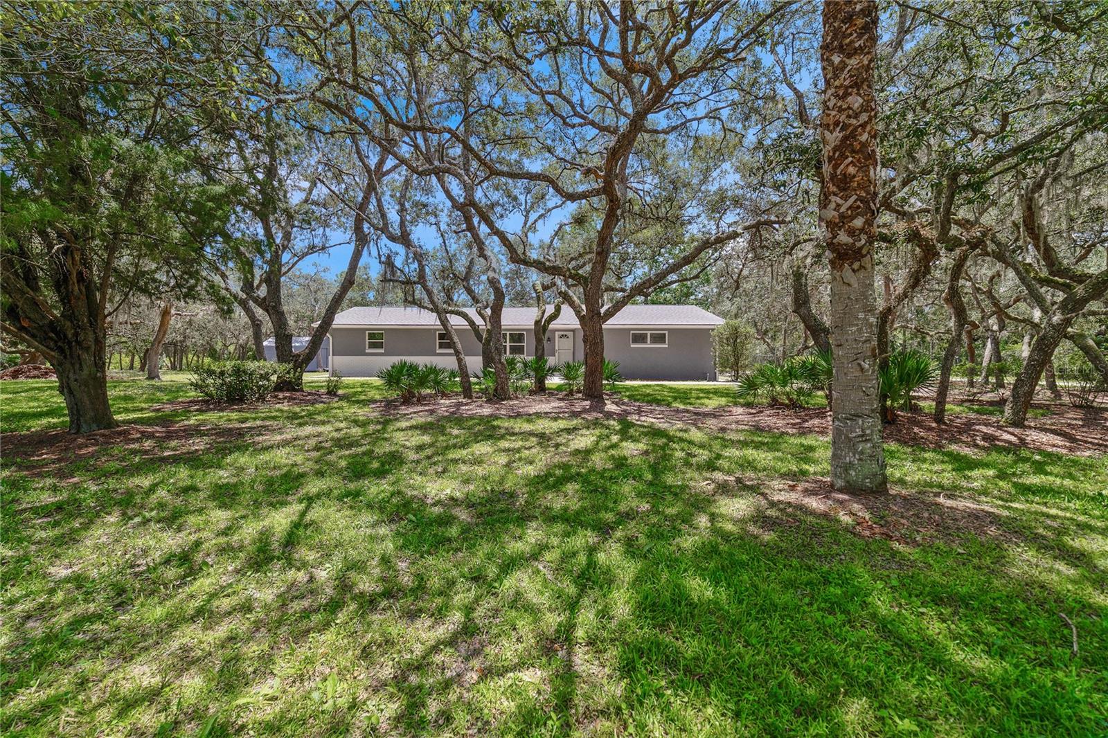 All the privacy you could want on OVER AN ACRE/CORNER LOT, in a PRIME LOCATION on the border of Chuluota/Oviedo - COMPLETELY RENOVATED and ZONED FOR A-RATED SEMINOLE COUNTY SCHOOLS including HAGERTY HIGH!