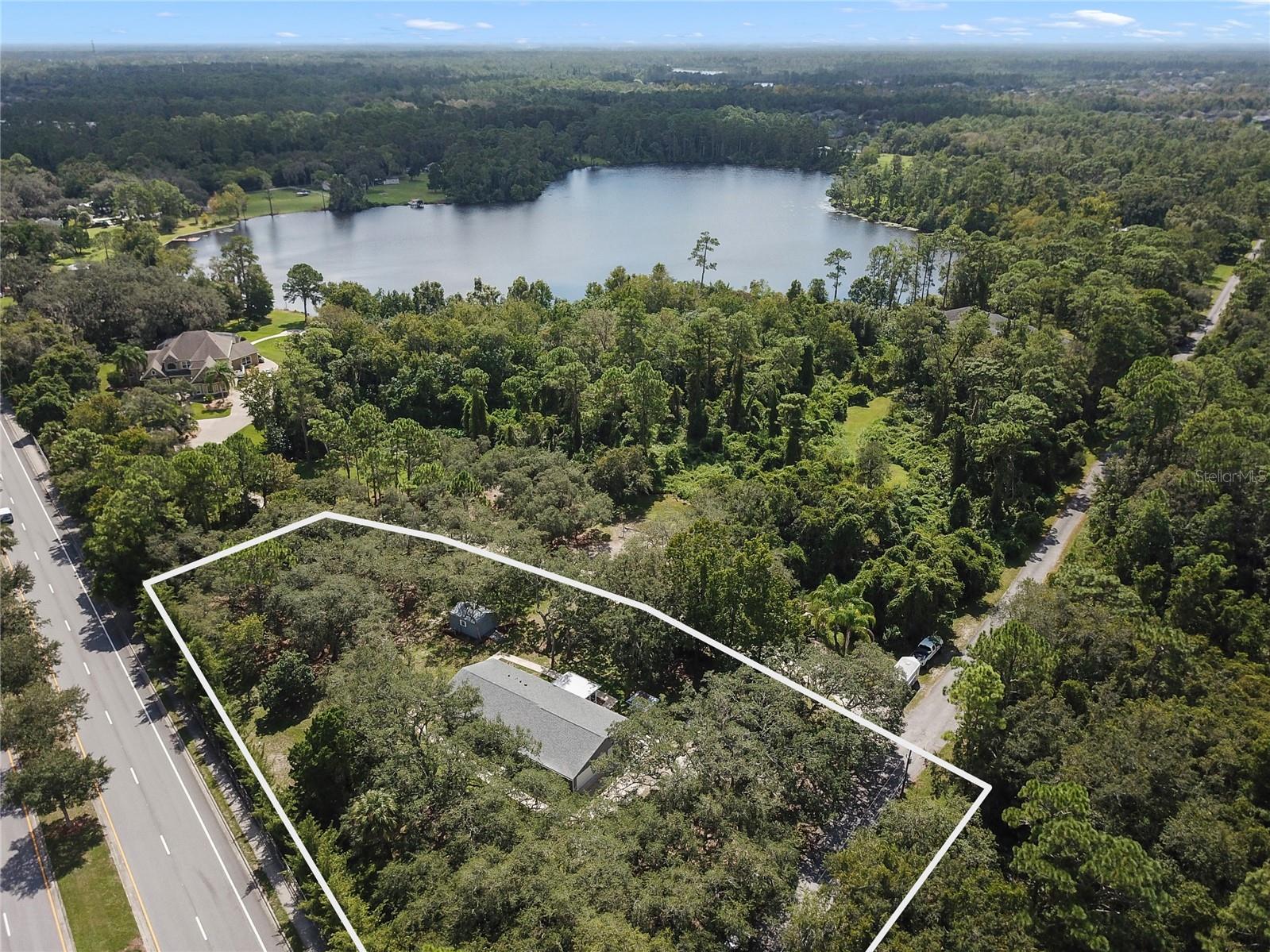Tucked away between the entrances of the highly sought-after Live Oak Reserve Community and surrounded by million dollar plus lakefront homes on Lake Eva, this 3BD/2BA home sits surrounded by gorgeous Oak trees making 1.13 acres feel like 3 with the added benefit of NO HOA!