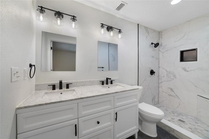 Your EN-SUITE has also been completely renovated in the same style as the kitchen with a DUAL SINK VANITY, chic light fixtures and a CUSTOM TILED SHOWER!
