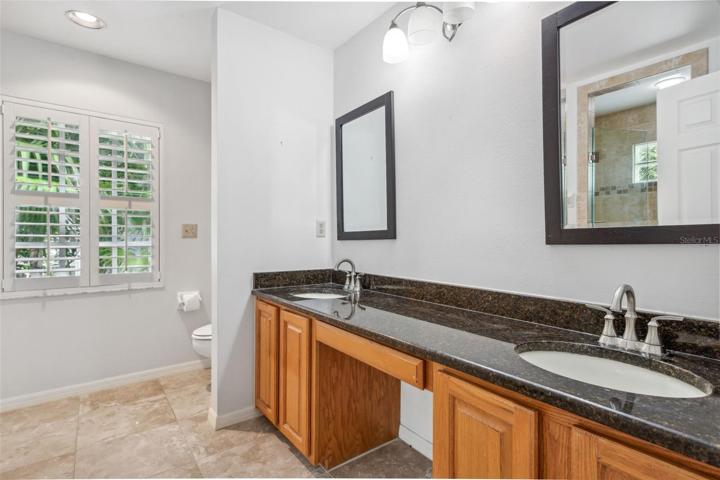 Ensuite owner's bath with double sink and vanity.