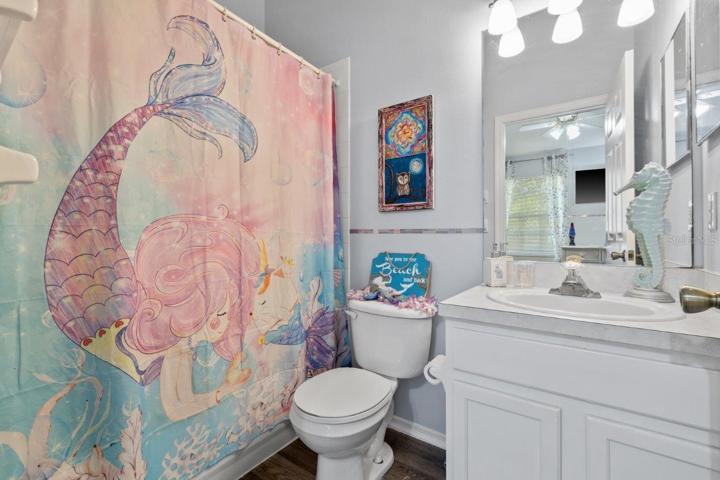 Second Bedrooms en-suite bathroom featuring a walk-in shower and laminate flooring.