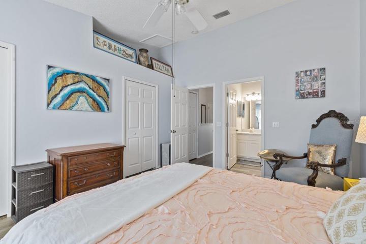 Main Owners suite featuring lamanite flooring, cathedral ceilings, and an ensuite bathroom