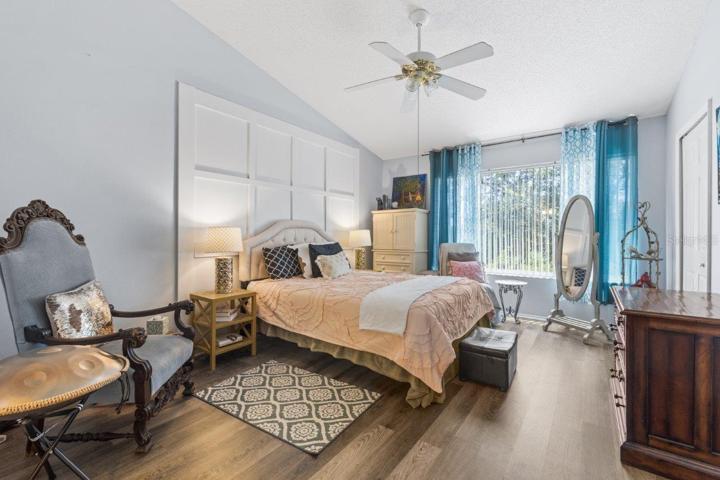 Main Owners suite featuring lamanite flooring, cathedral ceilings, and an ensuite bathroom