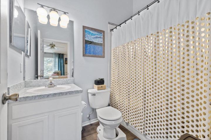 Main Owners en-suite bathroom featuring a walk-in shower, and laminate flooring