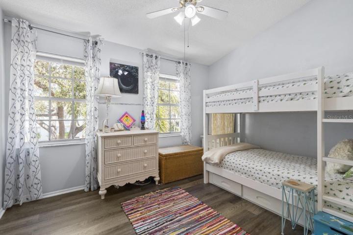 Second Bedroom Suite featuring lamanite flooring, and an en-suite bathroom.