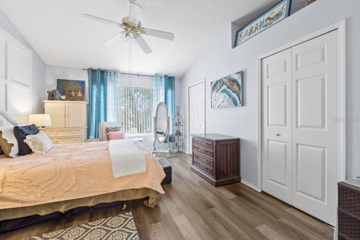 Main Owners suite featuring lamanite flooring, cathedral ceilings, and an ensuite bathroom