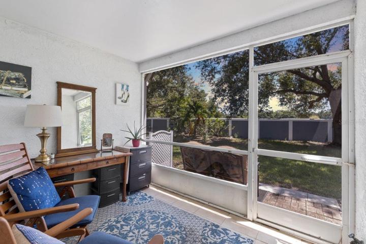 Tiled Screened-in Lanai with views of your semi-private back yard.