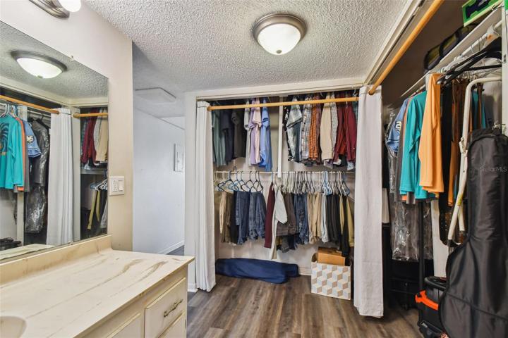 Two closets flank the vanity just outside of the bathroom