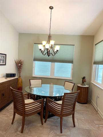 DINING AREA WITH VIEWS OF THE POOL AND GREENSPACE