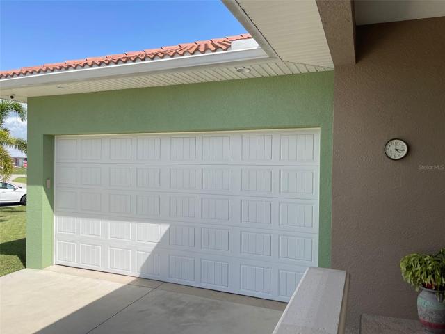 STYLISH GARAGE DOOR - LIGHTS IN SOFFIT... SOME OF THE MANY ADDED  DETAILS THROUGH THIS PROPERTY