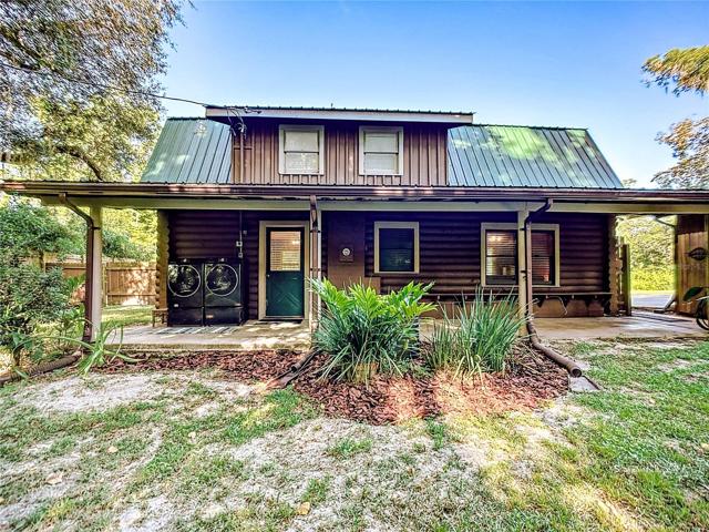 35 foot long x 8 ft. wide covered private back porch.  Whole house gutters & metal roof.