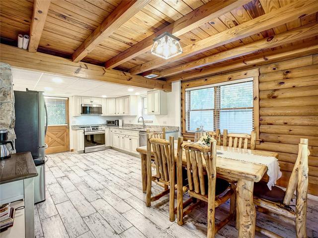 Completely renovated kitchen 2022. New electric in kitchen. Stainless Steel appliances with Bosch dishwasher.  New cabinetry, new flooring, new plumbing, new blinds & custom wood dining room furniture included!