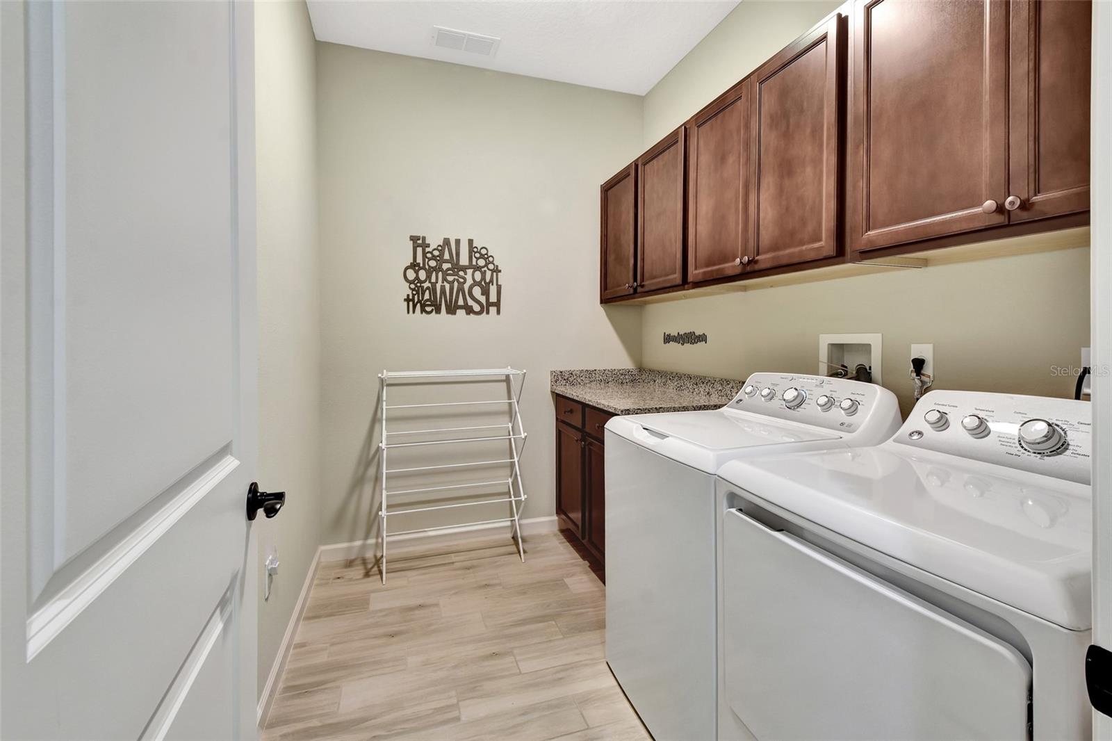 Laundry with extra cabinets and folding counter
