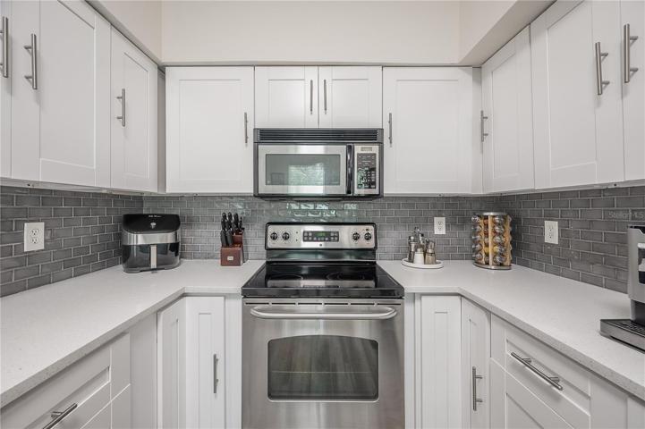 Shaker Cabinets, Quartz counters, and tile backsplash