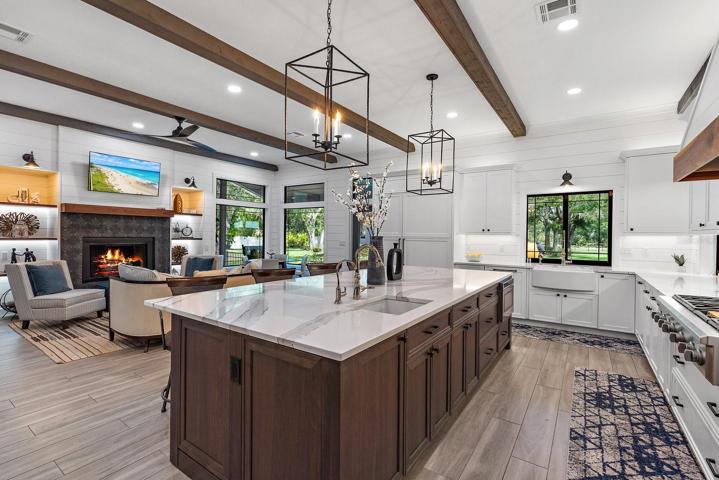 The heart of the house. A multitude of premium features adorn the kitchen/family room setting. Truly gorgeous quartz countertops from the Cambria "Luxury Series" are aptly named. Hickory mantle and shelving frame the newly tiled gas fireplace in the family room.