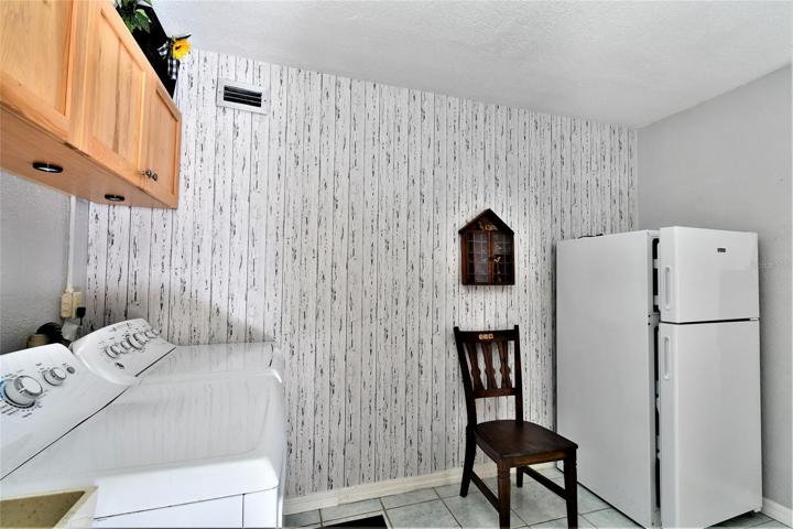 First floor laundry room and refrigerator