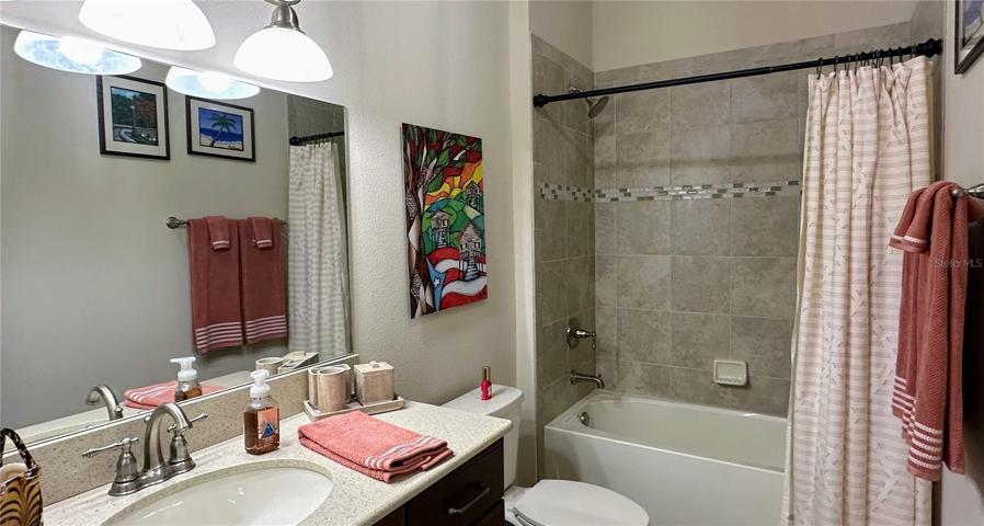Experience the epitome of convenience with the guest bathroom, thoughtfully designed to serve as a pool bath.