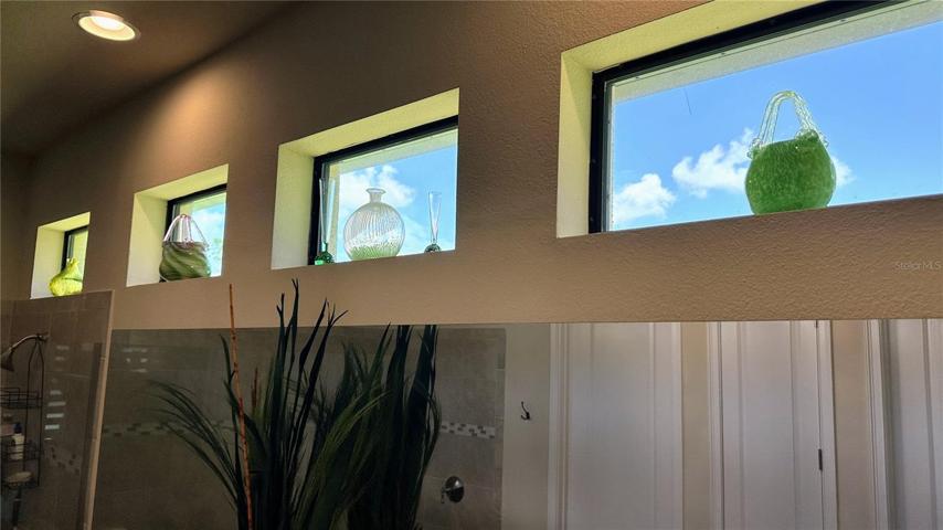 Upper transom windows usher in natural light, creating an ambiance of serenity.