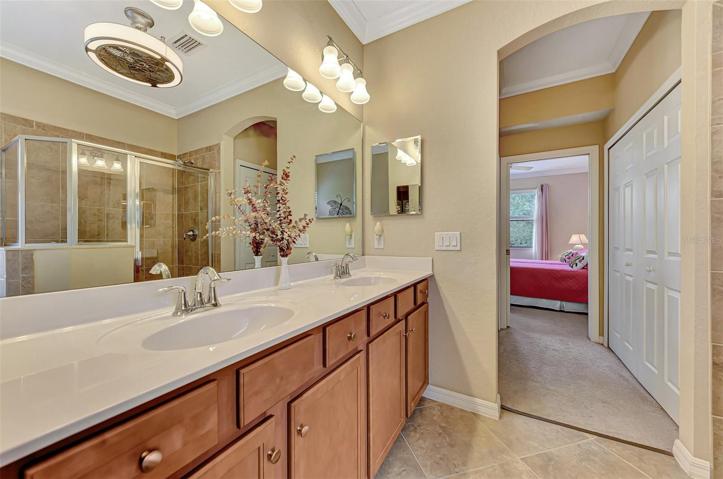 Separate Shower stall with tiled walls.