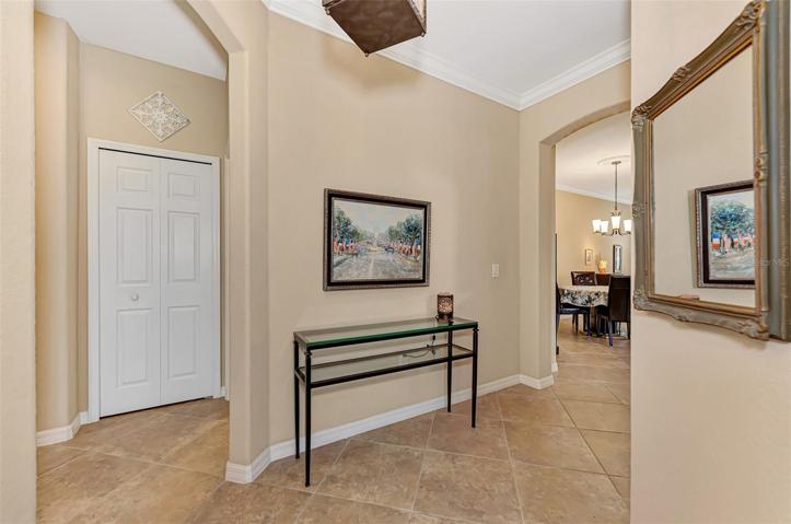 Tiled Foyer leads to guest bedroom & bath to the left, and to main living area on right.