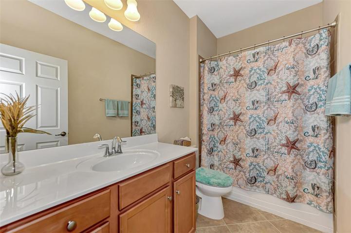 Spacious guest bath ample counter space. Tub/Shower combo has tiled walls.