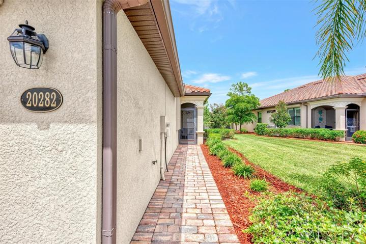 Paver walk-way to front door which is on the side of the villa.