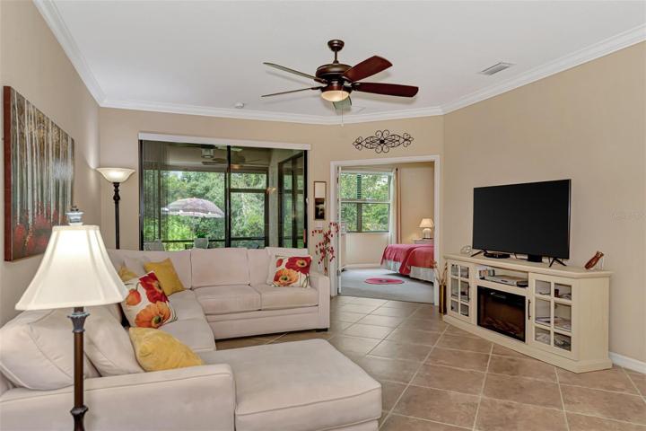 Sliders lead out to the enclosed lanai, French door opening on right leads to Master Bedroom.