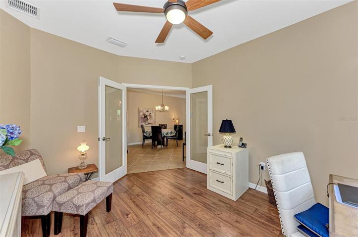 French doors can be fitted with curtains, blinds or plantation shutters for privacy. File cabinet to the right of the door does not stay with the home.