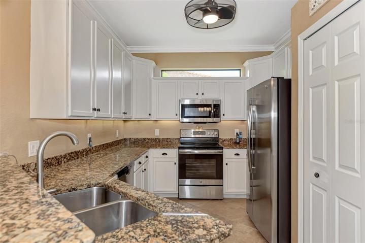 Double stainless steel sinks, lots of granite counter space.