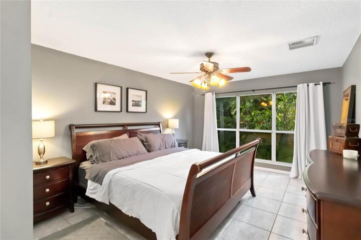 Downstairs primary suite with floor to ceiling windows