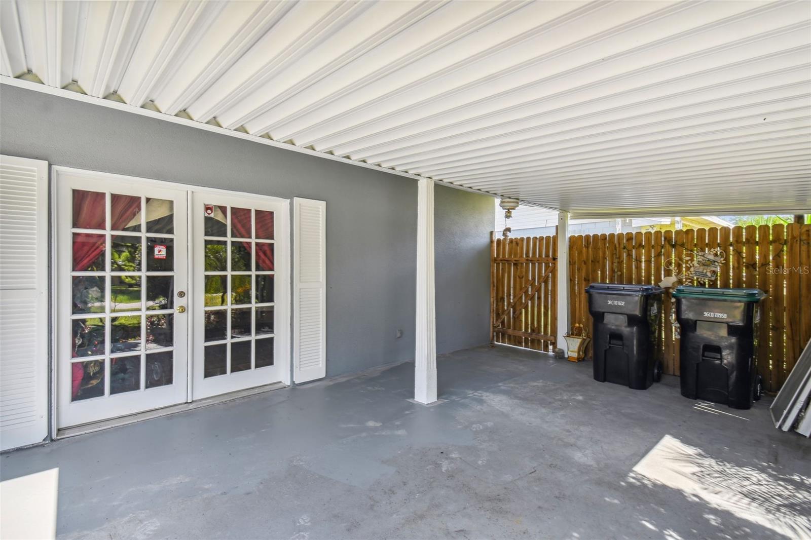 French doors from bonus room lead to covered patio