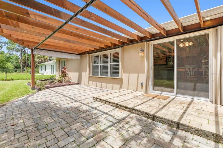 Paved Backyard Patio under Trellis
