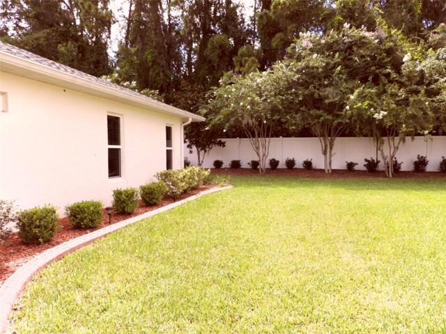 Lovely blooming crepe myrtle trees accent the back yard area.