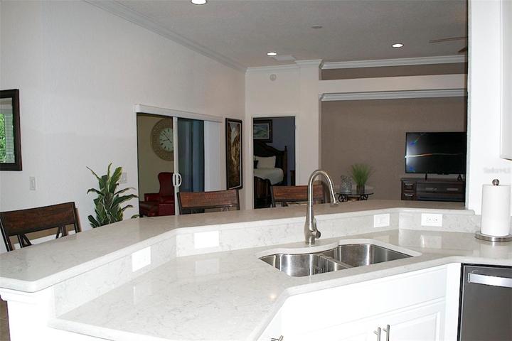 Keep in touch with company, with open view of dining, living room and lanai. Step up bar with stools.