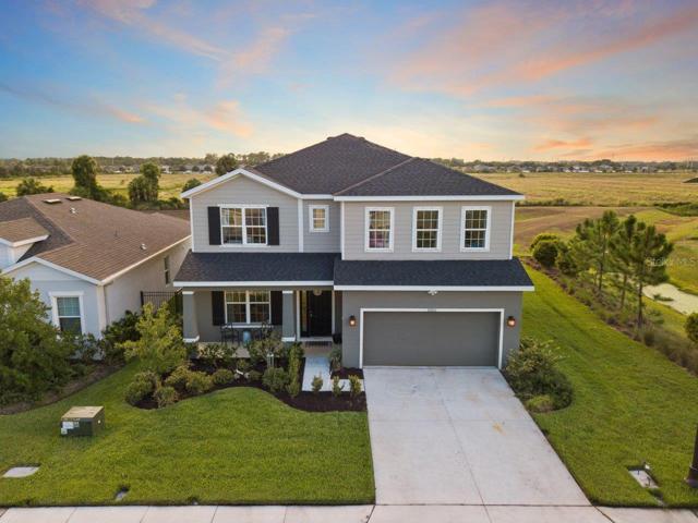 Aerial of the front elevation featuring the beautiful landscaping, and surrounding area