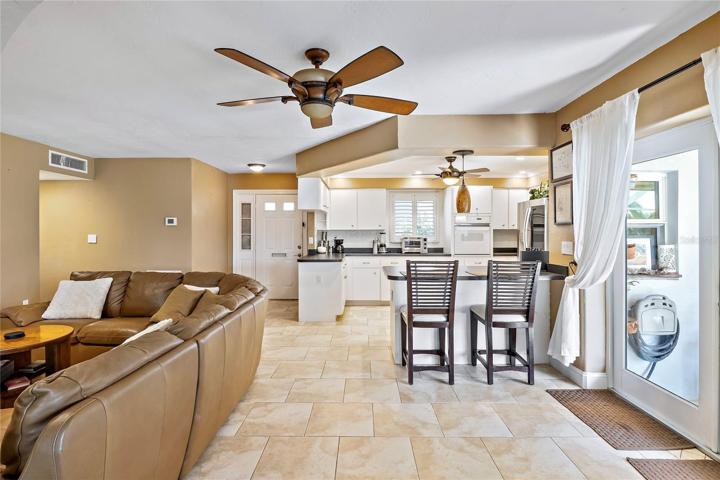 1st living space, front door, doors to lanai/pool & barber shop