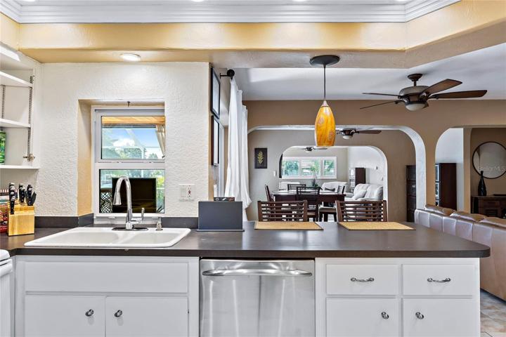 kitchen sink window looks to pool, breakfast bar