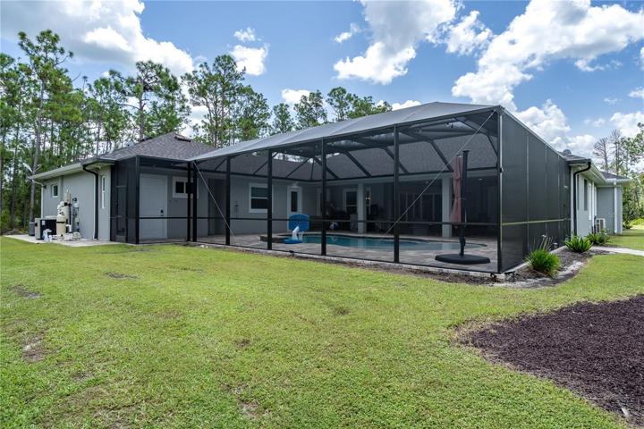 Back of home with screened pool