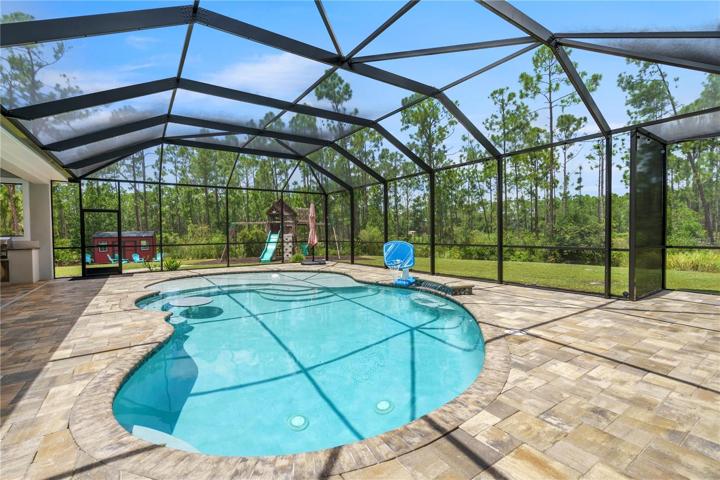 pool with sunning area and party table