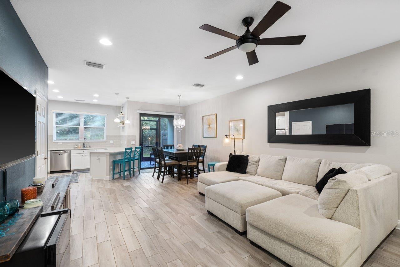 Great Room featuring wood look tile flooring, impact windows, and 10' ceilings.